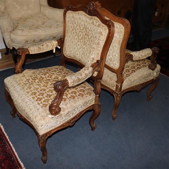 A pair of upholstered walnut armchairs